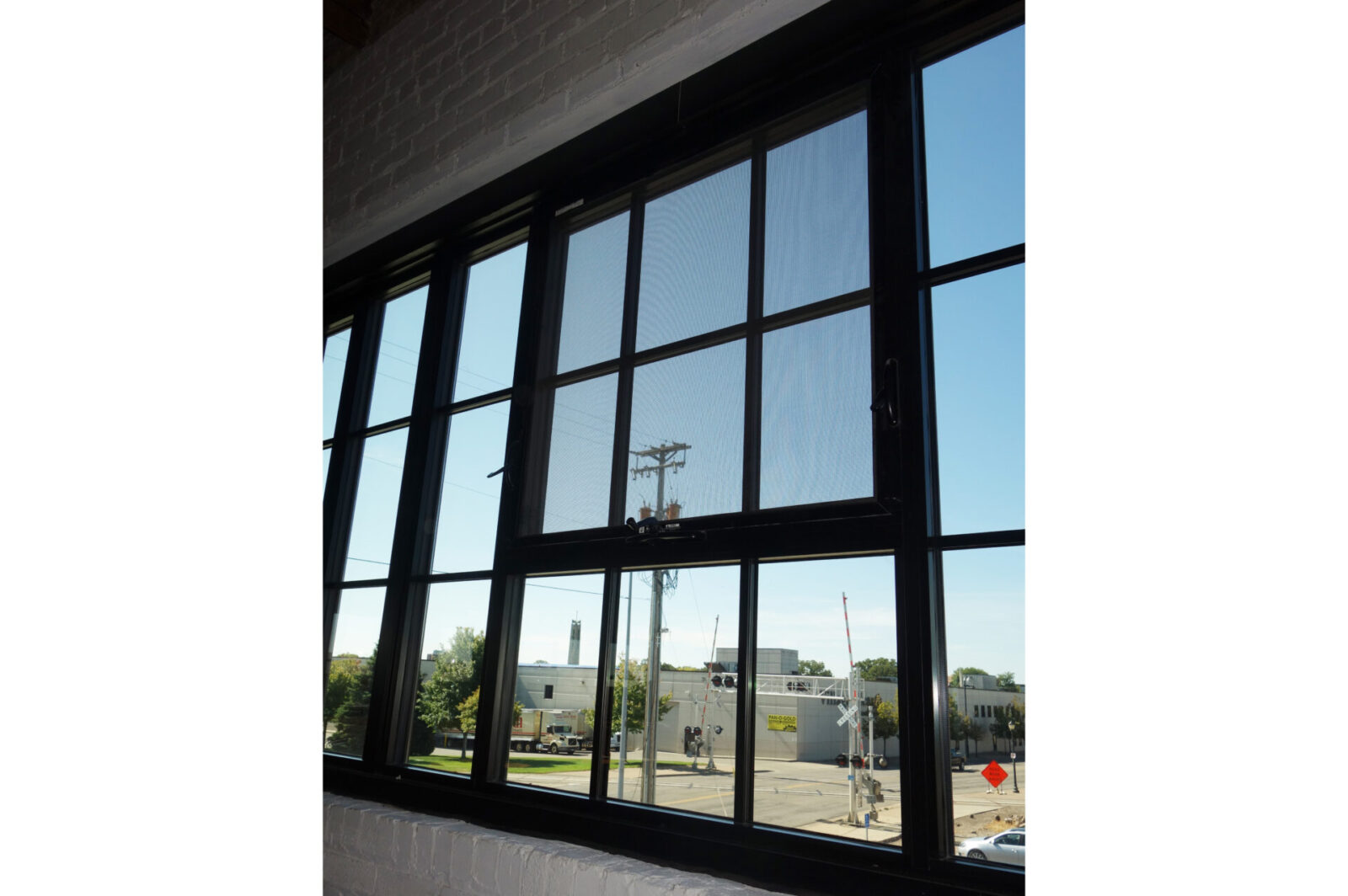 Harvester Square historic steel-replica awning window with screen