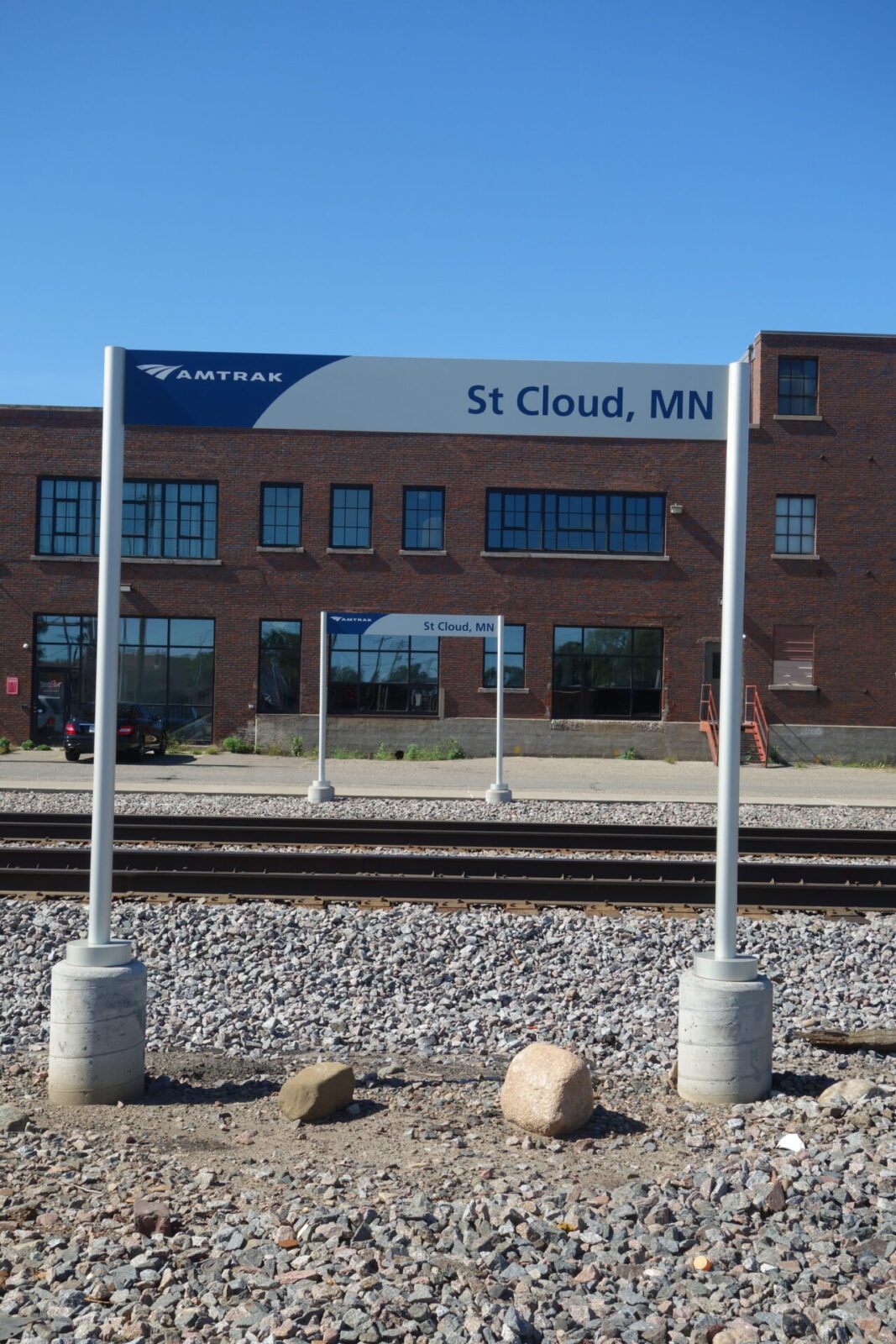 Amtrak signs in front of Harvester Square exterior historic replica windows
